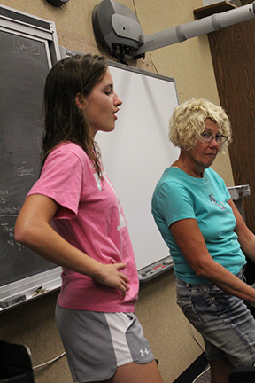 Hannah Musil and Mrs. Oatney work on one of Laurey's songs.